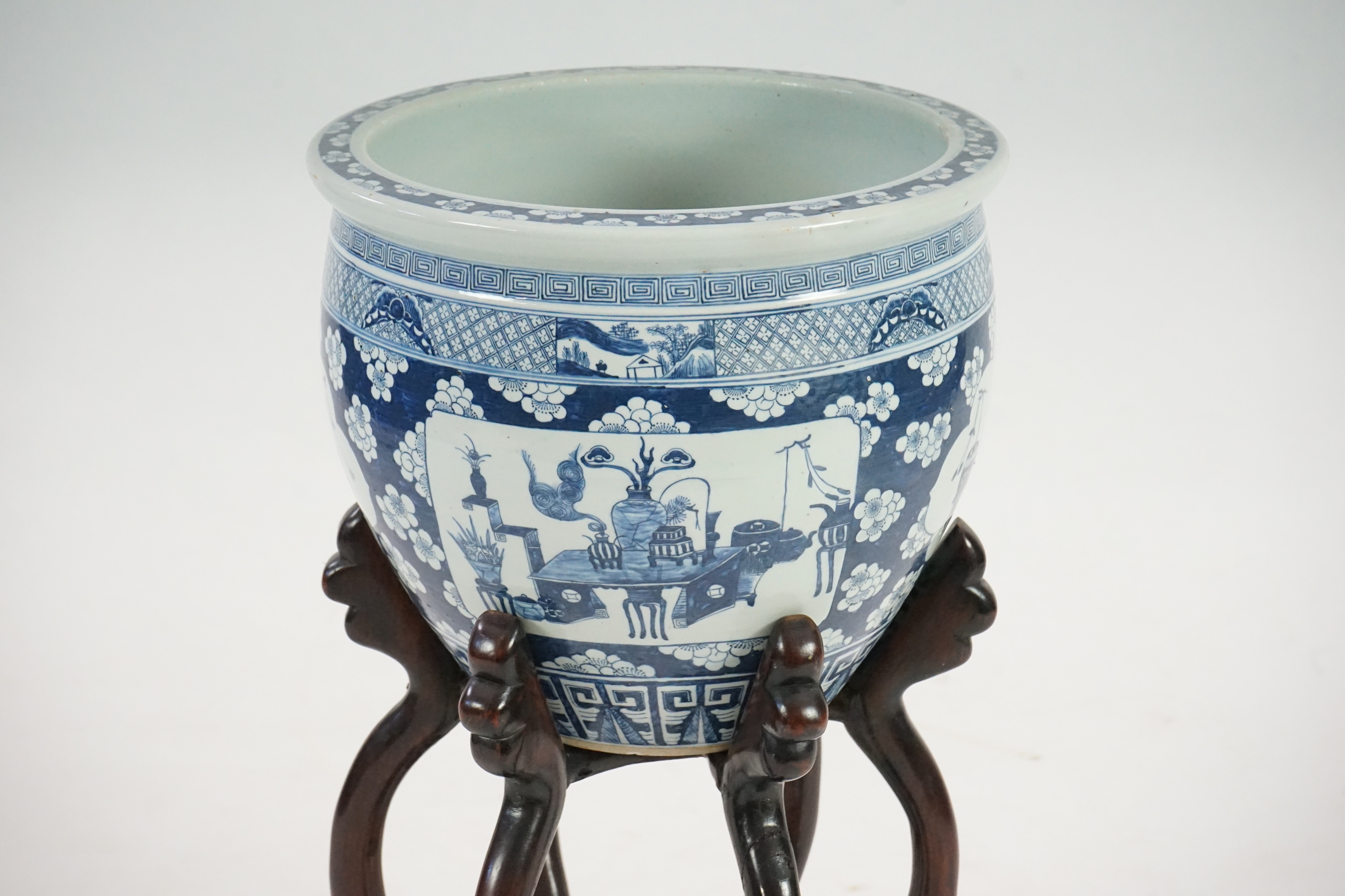 A large Chinese blue and white ‘Hundred Antiques’ jardinere and hongmu stand, late 19th/early 20th century